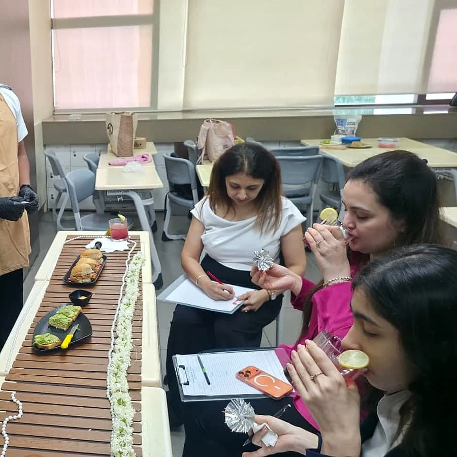 Keya tasting a drink as a Masterchef judge